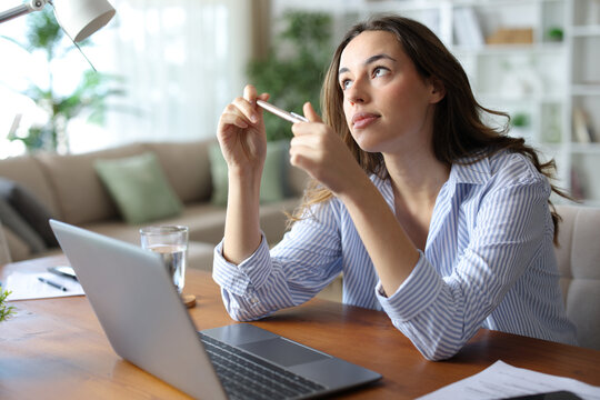 Distracted teleworker daydreaming working at home