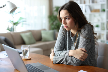 Sad woman tele working at home and complaining alone