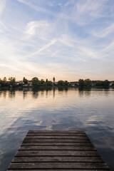 Fototapeta premium Rowboats at a wooden pier on Weßlinger See lake in Bavarian summer morning Weßling Bavaria 
