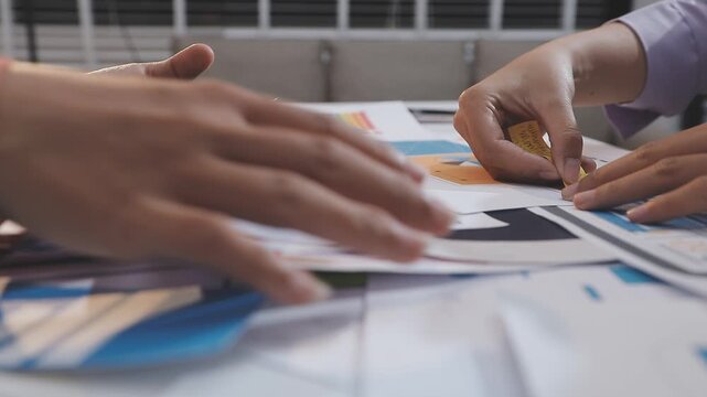 Asian uxui designer working on website design using sticky notes and wireframes