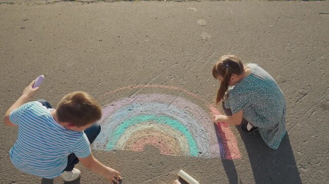 Kid child baby boy girl Children drawing outside, art on asphalt, rainbow chalk scene, creative kids playing, imagination in action, playful afternoon, summer art fun, colorful friends, pavement mural