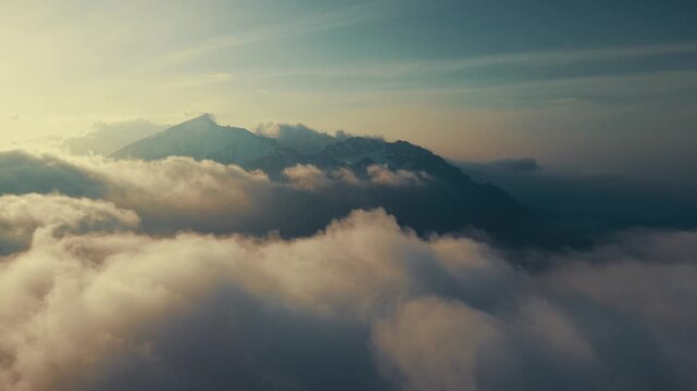 Aerial Drone Flight Above Clouds with Alpine Mountain Peak at Sunrise, Ges&auml;use, Austria,