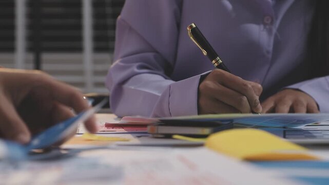 Asian uxui designer working on website design using sticky notes and wireframes