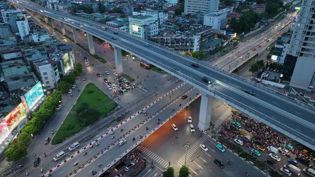 Aerial view of Giai Phong and Truong Chinh intersection in Hanoi with elevated overpass, busy traffic flow and dense urban surroundings at dusk