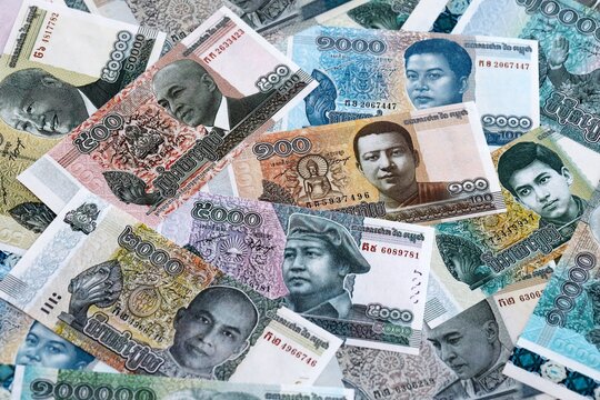 Cambodian riel money banknotes pile on table. Cambodia bills of KHR currency close up
