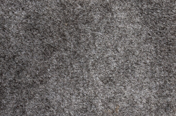 Fototapeta premium Top view of dark grey felt fabric texture with soft fuzzy surface and detailed organic fiber pattern for textile background