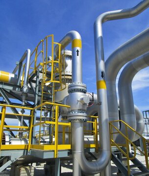 Insulated Gas Pipeline System With Valves And Yellow Platforms At LNG Plant