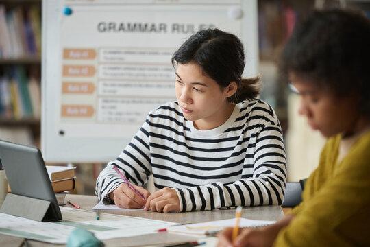 Students studying in a language class with focus on grammar rules