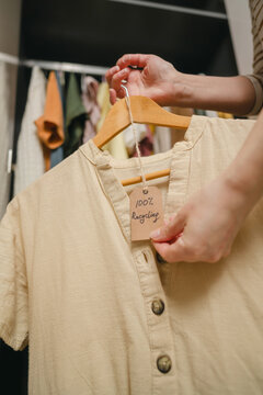 Sustainable organic shirt with 100 percent recycling tag in wardrobe