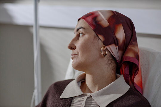 Patient with headscarf receiving chemotherapy treatment in clinic