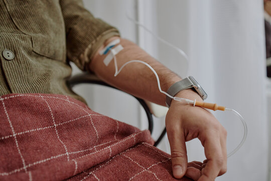 Patient receiving IV infusion in arm during medical procedure