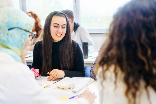 Students from different nationalities engaging in a classroom discussion