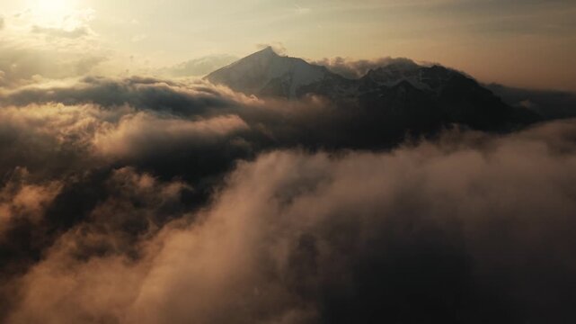 Aerial Drone Flight Above Clouds with Alpine Mountain Peak at Sunrise, Ges&auml;use, Austria