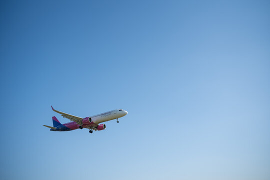 Bergamo, Italy - April 6, 2026: Dynamic shot of a commercial airplane landing at Orio al Serio Airport (BGY) in Bergamo, Italy, on a bright and sunny spring day