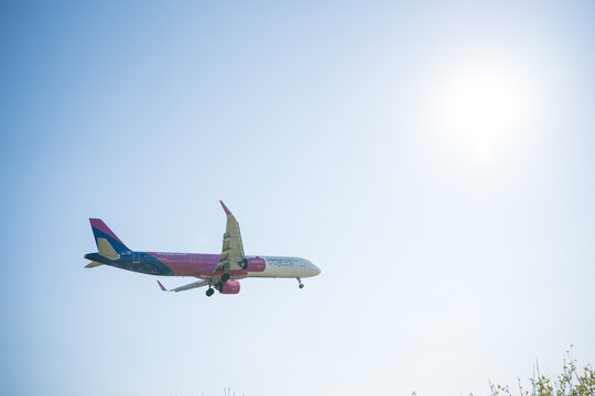 Bergamo, Italy - April 6, 2026: Dynamic shot of a commercial airplane landing at Orio al Serio Airport (BGY) in Bergamo, Italy, on a bright and sunny spring day