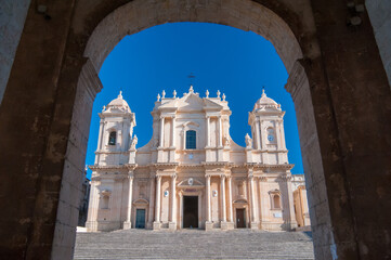 Obraz premium The Cathedral of San Nicolò in Noto, Sicily, seen from Palazzo Ducezio, headquarters of the local administration. The church in one of the best examples of the baroque architecture in the island