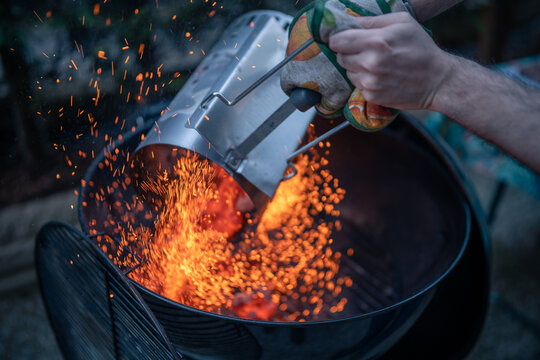 Close up on braces inside a BBQ ready to cook, sparks are visible.