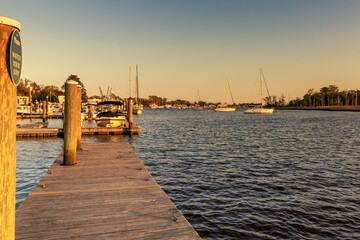 Fototapeta premium view of the historic boardwalk and waterfront of downtown Georgetown at sunset