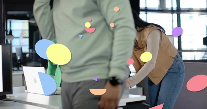 Man walking front blocking while 3 team leaning pointing reviewing laptop with animated shapes