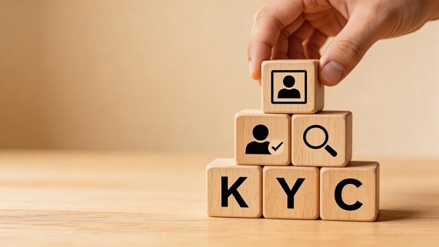 Hand placing wooden block with user icon on top of KYC pyramid symbolizing customer identity verification compliance due diligence and secure digital onboarding process for