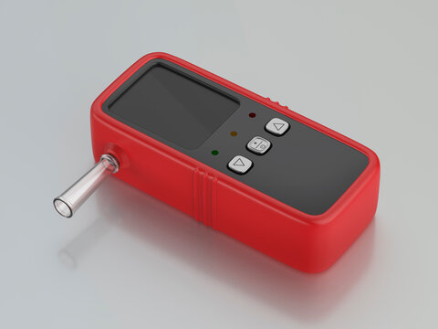 Red digital breathalyzer for alcohol testing on shiny grey background