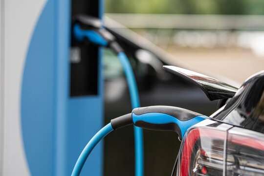 Electric mobility in Germany with vehicle charging as cable and plug connect car to power and energy for cleaner transport future now
