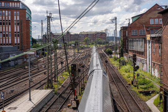 Railway infrastructure in Hamburg Germany with urban industrial tracks and train perspective for transport corridor under cloudy daylight