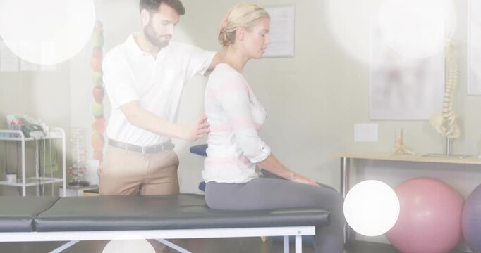 Therapist placing hands on patient, starting spinal neck exam on table, bokeh overlay clearing