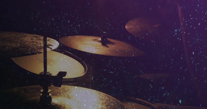 Drumsticks entering, drummer arms striking cymbals, performing music, particles flaring per strike