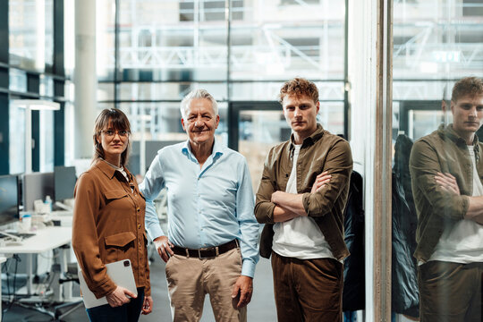 Modern office teamwork in agency with professionals and glass architecture