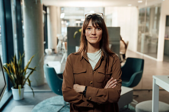 Businesswoman standing confidently in modern office workspace