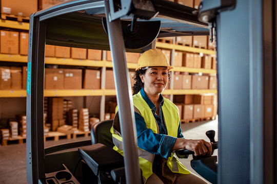 Female forklift operator working in warehouse