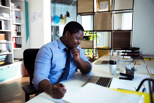 Business professional working on laptop in modern office