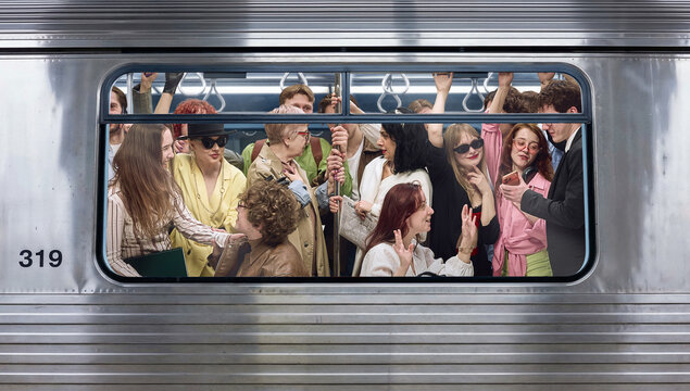 Crowded subway carriage seen through window with passengers interacting. Concept of mobile usage, digital consumption, social media behavior, connected lifestyle, and urban communication.