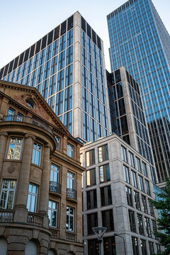Street scene in Frankfurt Germany Bankenviertel with heritage architecture and modern office skyscraper emphasizing contrast between eras