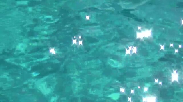 Azure blue water reflects the sun's rays and shimmers like stars. The sun caresses the water and sparkles majestic 