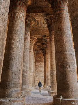 Colonnade interior with visitor at the Temple of Khnum in Esna Egypt