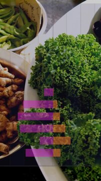 Vertical video: Pulling back revealing hand lifting ginger prepping salad bars moving over kale