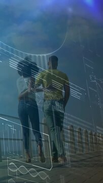 Vertical video: Couple walking on deck by ocean, sparking tech charts into map overlay for love