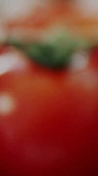 Vertical video: Single ripe tomato food macro, focus racking showing droplets HUD testing ripeness