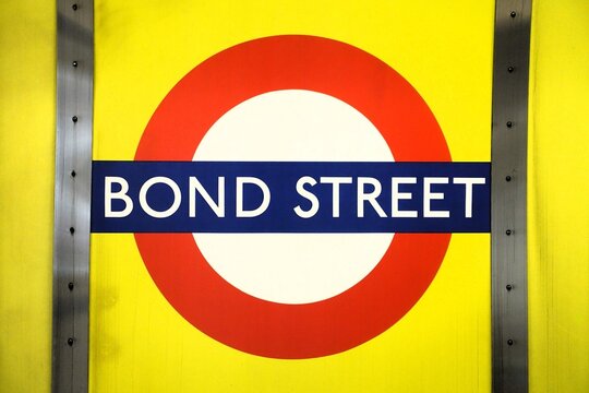 The famous sign representing the London Underground is located at Bond Street station, a district known for its luxury shopping.