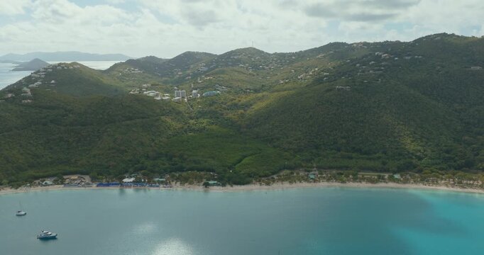 Aerial View Of Magens Bay Beach In St. Thomas, US Virgin Islands, With Turquoise Waters, White Sand, And Forested Hills On Coast. pullback shot