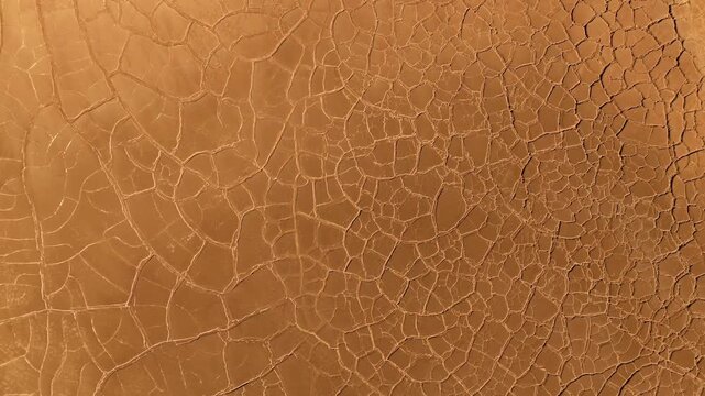 Aerial view of the unique cracked red mud patterns and dry mineral deposits in the mining landscape of Minas de Riotinto, Andalusia, Spain.