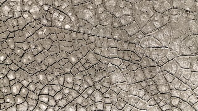 Aerial view of intricate cracked earth patterns and dry mud texture in Minas de Riotinto, Andalusia, Spain.
