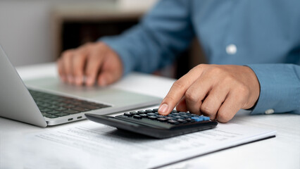 Modern business accounting management: Using technology for efficient tax calculations, accounting, assets, balance sheets, stock market statistics, and annual tax laws to protect businesses. © Wachirapong