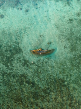 Aerial view of a shipwreck resting peacefully beneath the turquoise waters, a silent testament to time in Goro, South Province, New Caledonia.