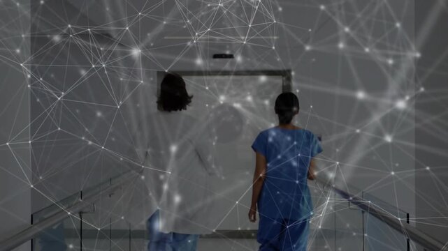 Walking doctor in lab coat and nurse in scrubs heading down hospital corridor, with network overlay