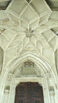 Catedrala Evanghelică Sf&acirc;nta Maria entrance with carved wooden doors, pointed arch portal, and ribbed vault in Sibiu. Highlights Gothic stone craftsmanship and Transylvanian religious heritage.