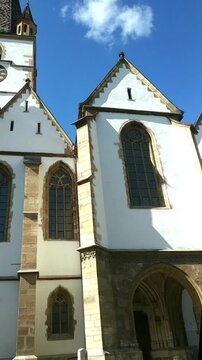 Panoramic view of facade of Sibiu's Evangelical Cathedral of Saint Mary. Illustrates Transylvanian Gothic heritage, Central European cultural identity, and visual splendor of Romania's medieval church