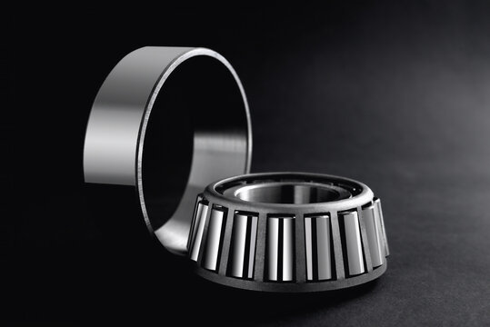 roller bearings on a black background, blank for creativity. Parts for machines and mechanisms in rotation units.